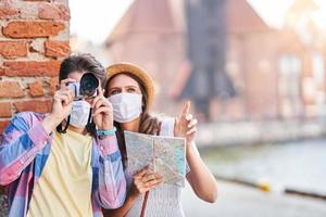 Adult tourists in masks sightseeing Gdansk Poland photo