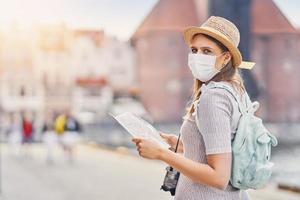 Female tourist wearing a mask sightseeing Gdansk Poland in summer photo