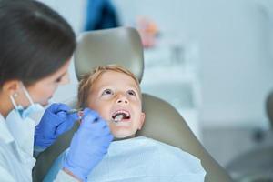 Little boy and female dentist in the dentists office photo