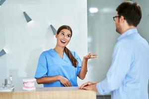 Patient paying for dental visit in clinic photo