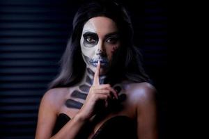 Spooky portrait of woman in halloween gotic makeup photo