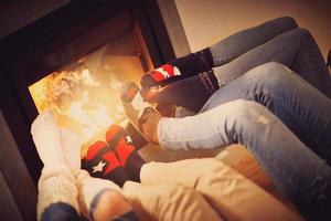 Legs of group of friends relaxing over the firepllace photo