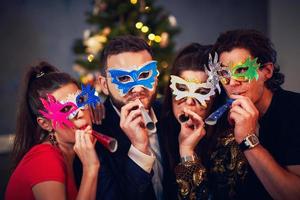 Two beautiful young couples having fun at New Year's Eve Party photo