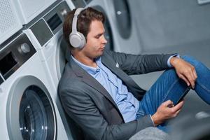 Young businessman in laundry room photo