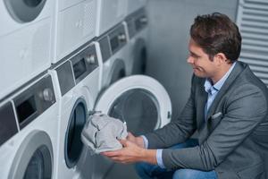 Young businessman in laundry room photo