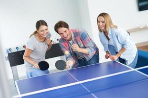 Group of students playing table tennis in the campus photo