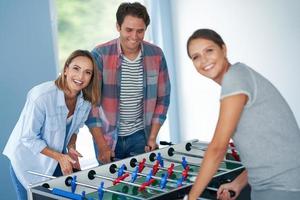 Group of students playing table soccer in the campus photo