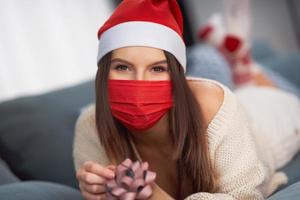 Adult woman with Christmas present at home photo