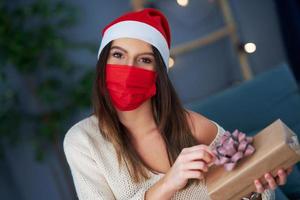 Adult woman with Christmas present at home photo