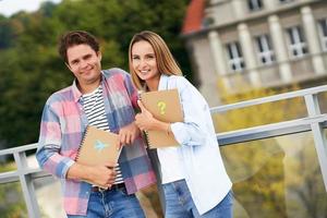 Couple of students standing together in the campus photo