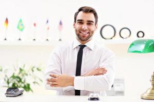 Happy receptionist working in hotel photo