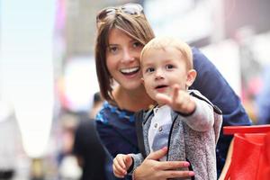 Mother having fun with her little son in Times Square photo