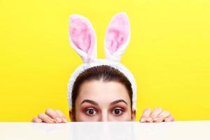 Happy young woman wearing bunny ears photo