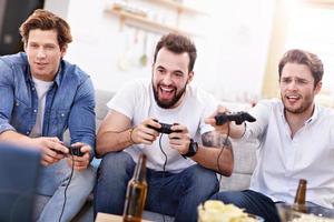 Friends having fun on the couch with video games photo