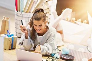 Adult woman at home wrapping Christmas presents photo