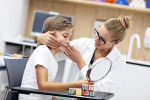 Cute little boy at speech therapist office photo