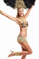 Brazilian woman posing in samba costume over white background photo