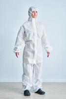 Woman in bio-hazard suit on white background. photo