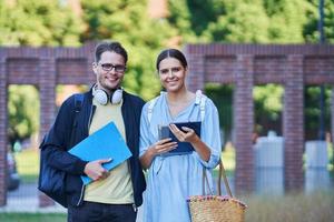 Couple of students in the campus studying outdoors photo