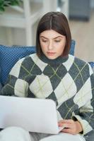 Teenage girl having online classes at home photo