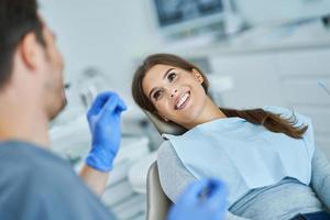 Male dentist and woman in dentist office photo