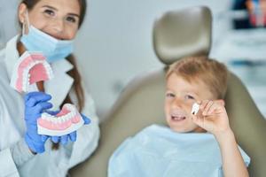 Little boy and female dentist in the dentists office photo