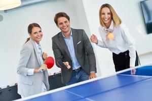 Business people relaxing in shared office space photo