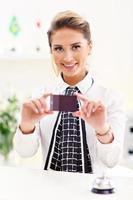 Happy receptionist working in hotel photo