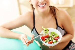 Woman doing fitness exercises at home resting on ball photo