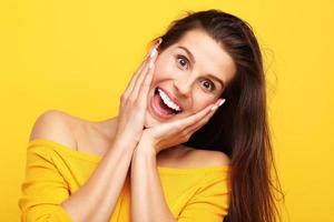 Woman against yellow wall background photo