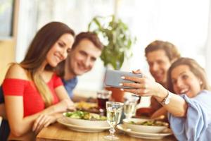 Group Of Friends Enjoying Meal In Restaurant photo