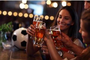 Group of friends watching soccer in pub photo