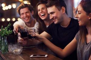 Group of friends watching soccer in pub photo