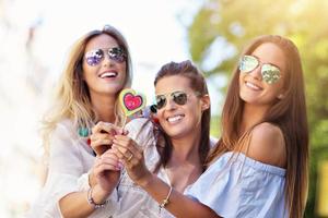 Happy girl friends hanging out in the city in summer photo