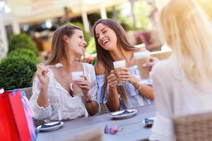 Happy girl friends in cafe during summer time photo