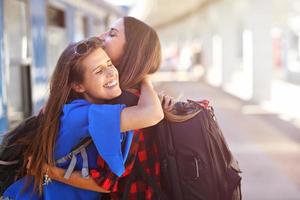 Girl friends tourists on railway platform photo