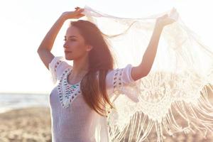 Beautiful sexy woman at dusk on the beach photo