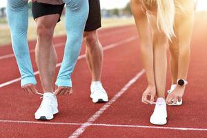 Man and woman racing on outdoor track photo