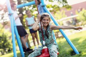 Joyful family having fun on playground photo