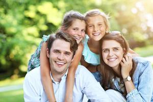 Young family with children having fun in nature photo