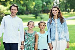 Young family with children having fun in nature photo