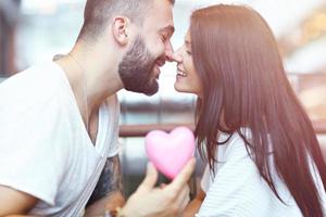 Romantic couple dating in cafe and holding presents photo