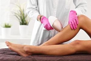 Adult woman having laser hair removal in professional beauty salon photo