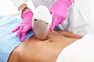 Adult woman having laser hair removal in professional beauty salon photo