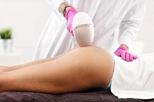 Adult woman having laser hair removal in professional beauty salon photo