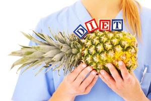 Healthy pineapple with doctor and lettering photo