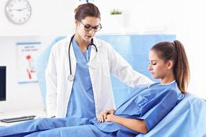 Female doctor taking care of patient in hospital photo