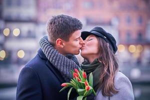 Happy couple celebrating Valentines Day in masks during covid-19 pandemic photo