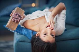 Adult woman holding present at home photo