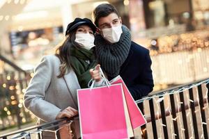 Happy couple celebrating Valentines Day in masks during covid-19 pandemic photo